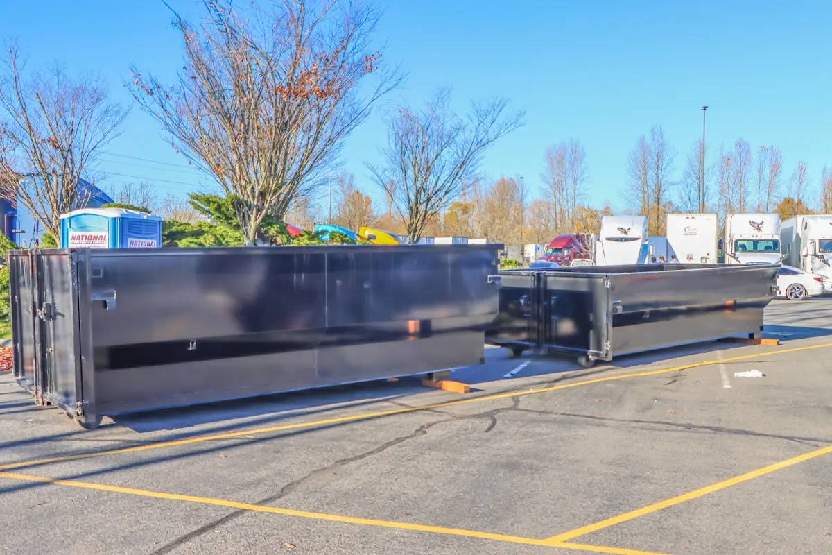 Professional dumpster rental service with roll-off container on residential driveway in South Ogden